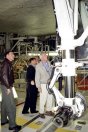 Retired Navy Adm. Harold Gehman Jr. (right) checks out Atlantis' landing gear with members of the CAIB during a visit to KSC. NASA photo.