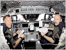 STS-108 Commander Dom Gorie (left) and pilot Mark Kelly pose for a portrait inside Space Shuttle Endeavour's cockpit. Image courtesy of NASA.