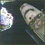 NASA image of Space Shuttle Endeavour undocking from the International Space Station. At left, is the station's Pressurized Mating Adapter to which the shuttle's Orbiter Docking System (circular object in payload bay) was attached.