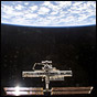 The International Space Station, with sunlight glinting off its solar arrays, as seen from Endeavour's post-undocking flyaround. NASA photo.