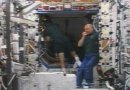 Don Pettit helps the Shuttle crew out the Pressurized Mating Adapter connecting the two spacecraft. Image: NASA TV/NewsFromSpace.com