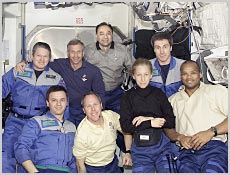 A portrait of the STS-98 and Expedition One crews inside the newly attached U.S. Laboratory. NASA image.